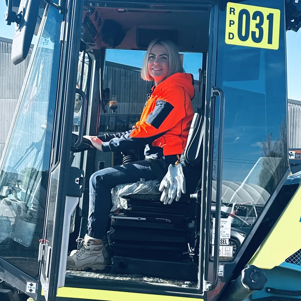 Justine Youl in the cab of a road-maintenance roller on site